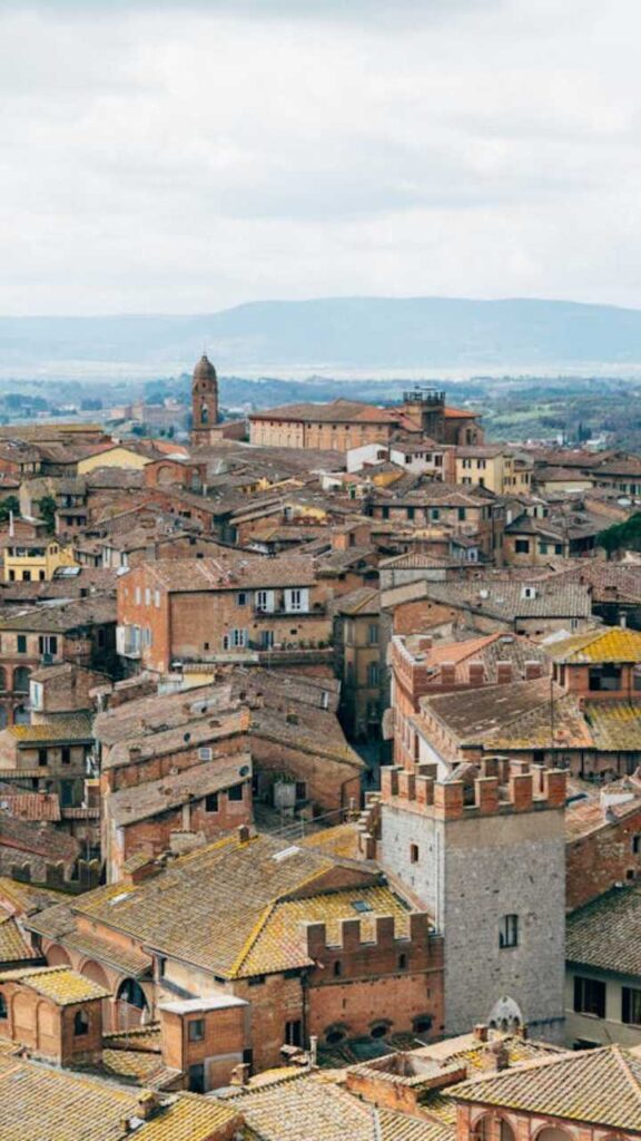 Panoramic view of Siena with terracotta rooftops and historic towers in Tuscany, Italy