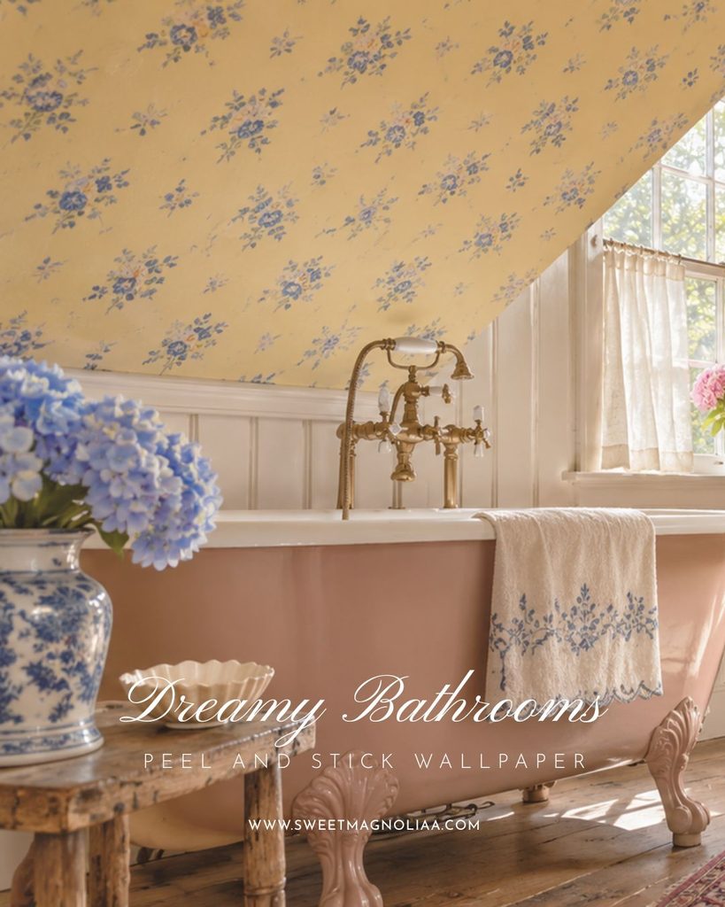Pink clawfoot tub with a brass telephone tap under a sloped attic ceiling covered in yellow wallpaper with blue bouquets in a cozy cottage bathroom